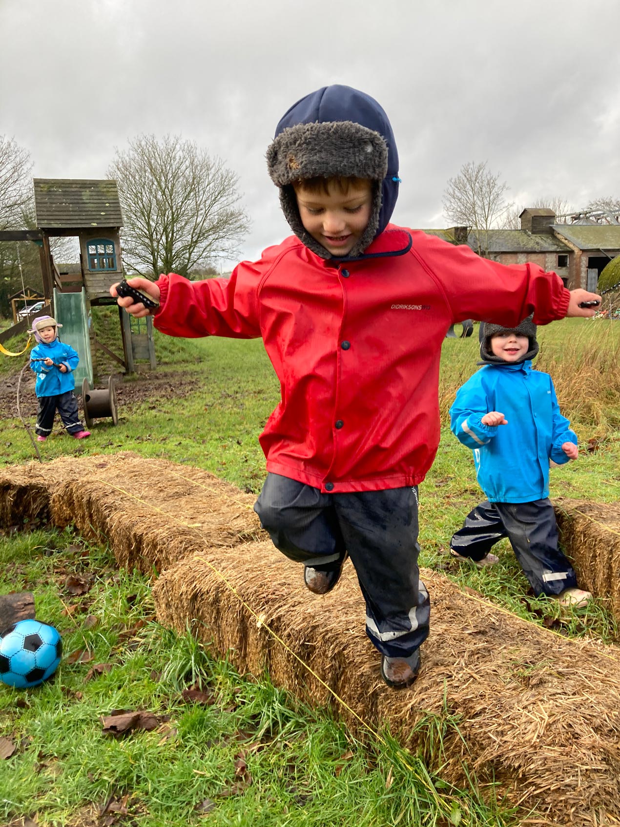 EYFS outdoor balance track activity promoting toddler gross motor coordination, risk management, and physical confidence.