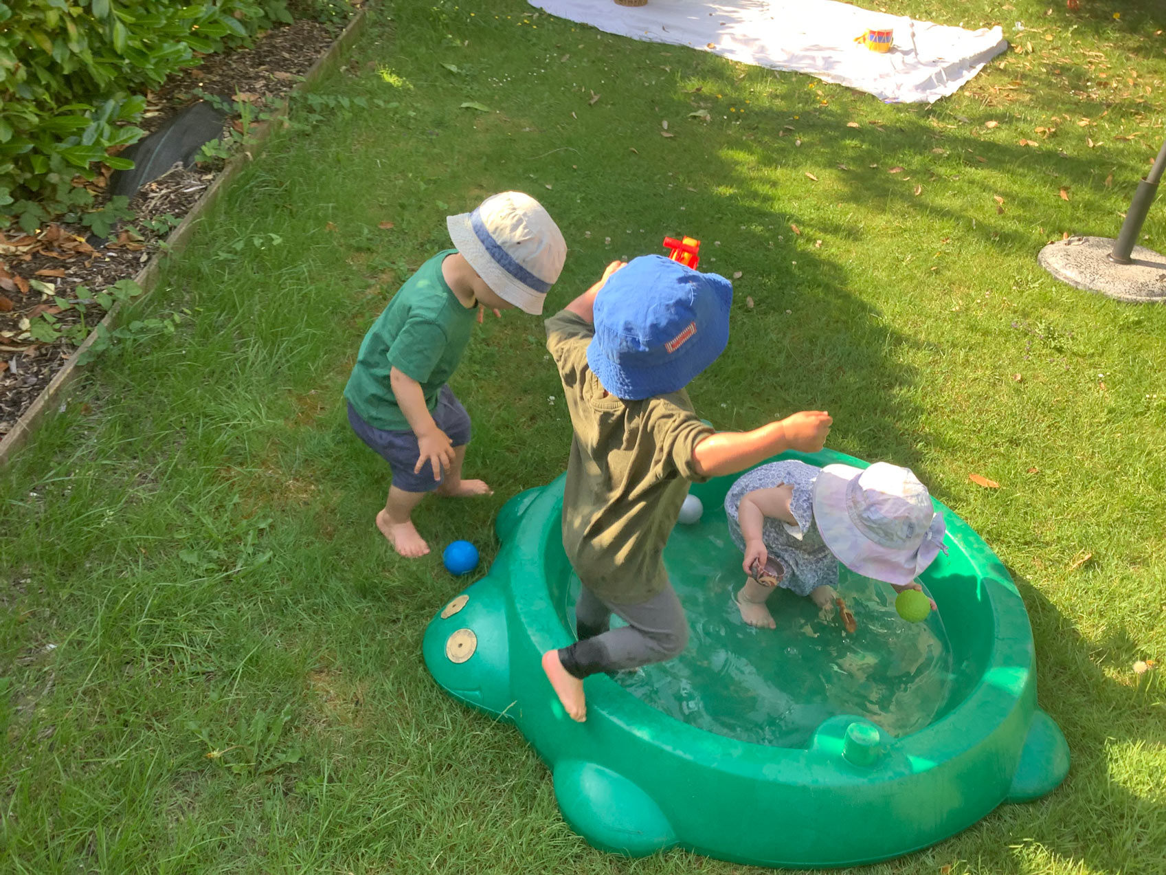 Toddlers playing in outdoor pool the Family Nest