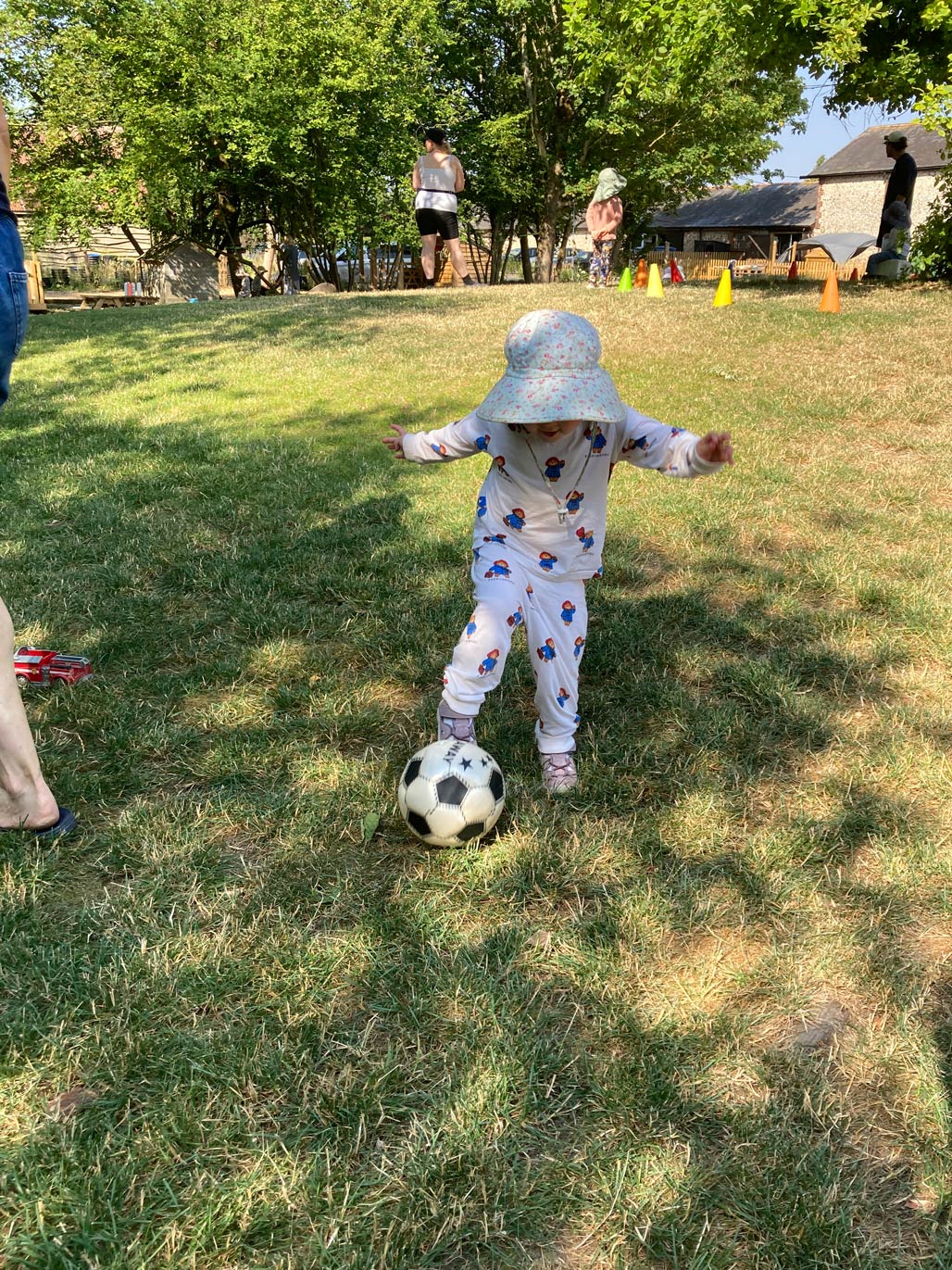 Child playing with football outdoors