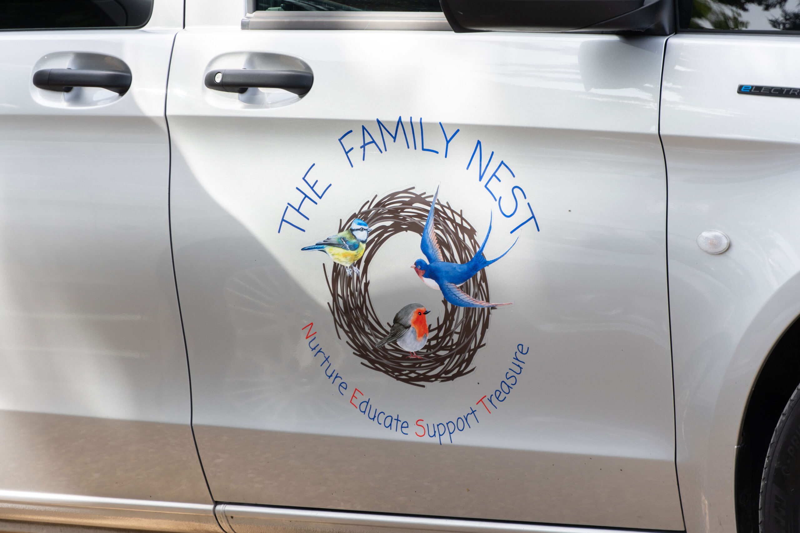 The Family Nest company vehicle, Nurture, Educate, Support, Treasure.