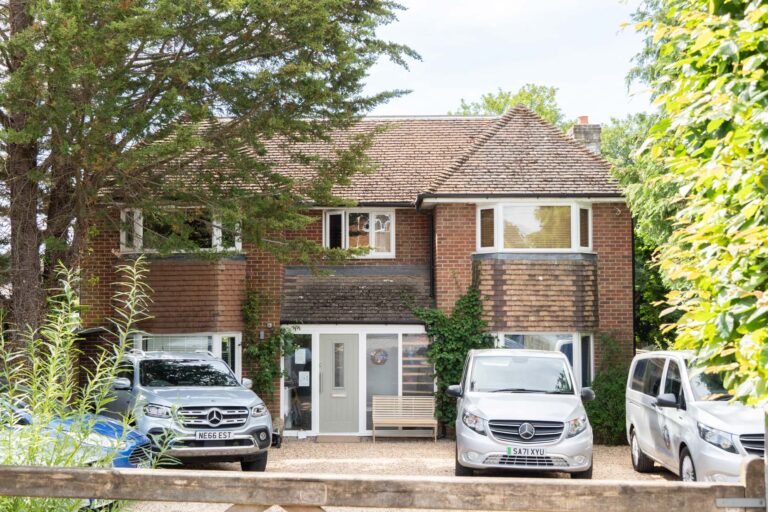 The Family Nest driveway with company vehicles