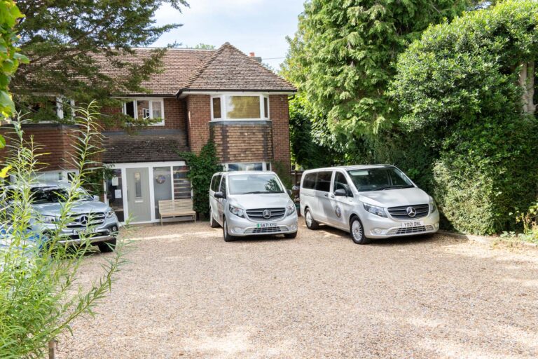 The Family Nest driveway with company vehicles.