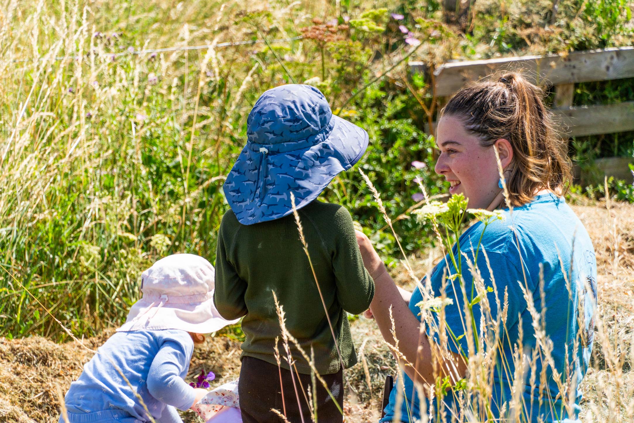 Nest team member and child admiring a flower at the Pheasant Nest