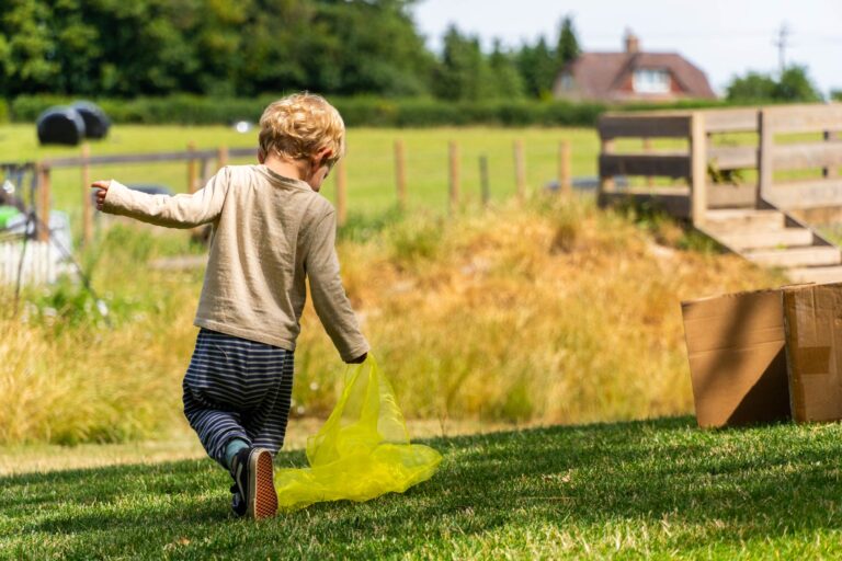 Child playing at the Pheasant Nest, play equipment visible in the background.